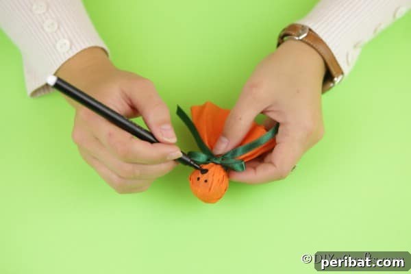 Drawing a face on the ghost lollipop