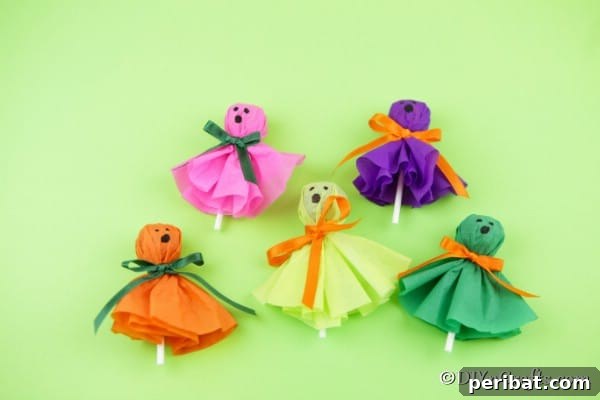 Ghost lollipops laying on a green surface