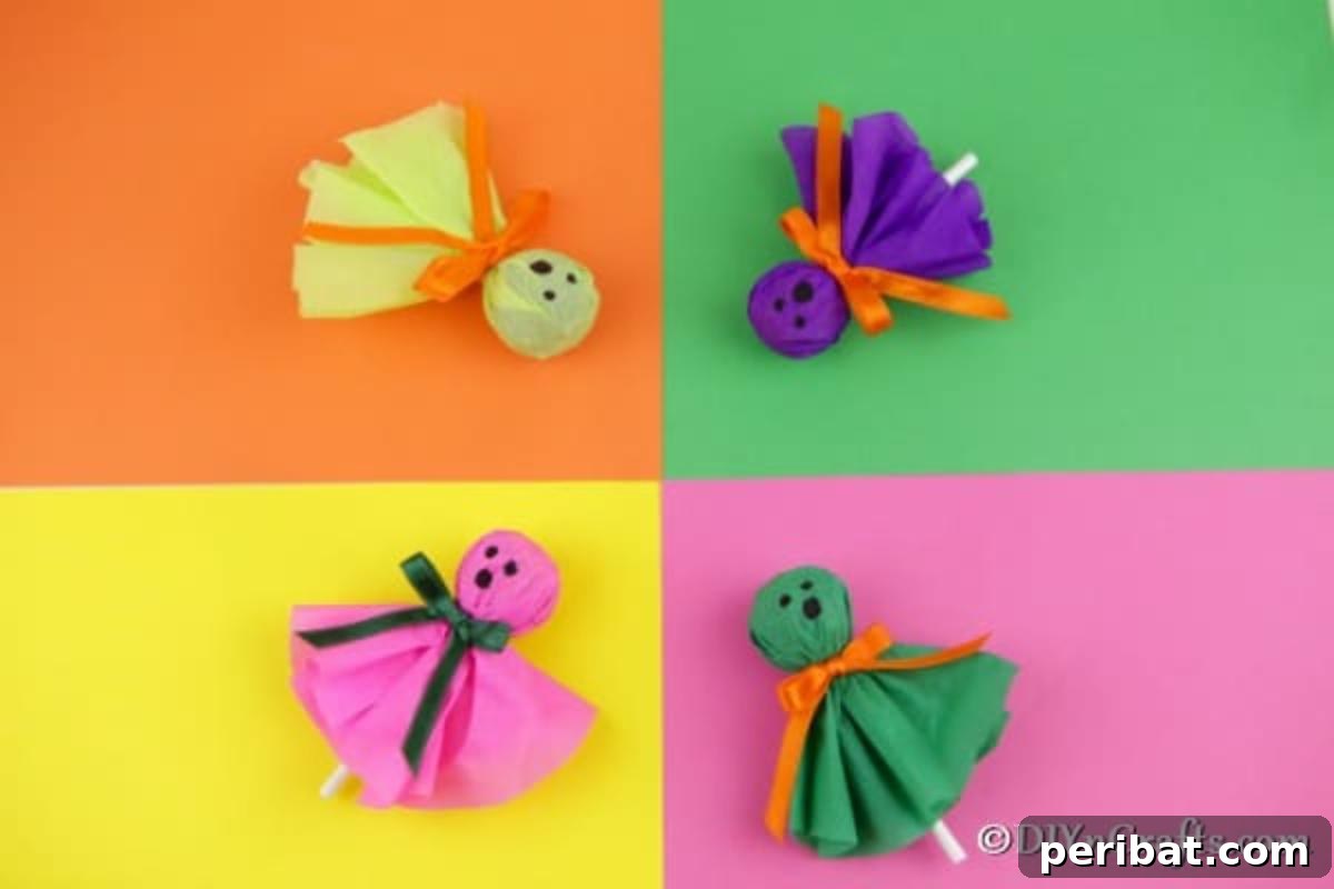 A charming variety of ghost lollipops, each with a unique face, displayed on different colored papers for a festive Halloween look.