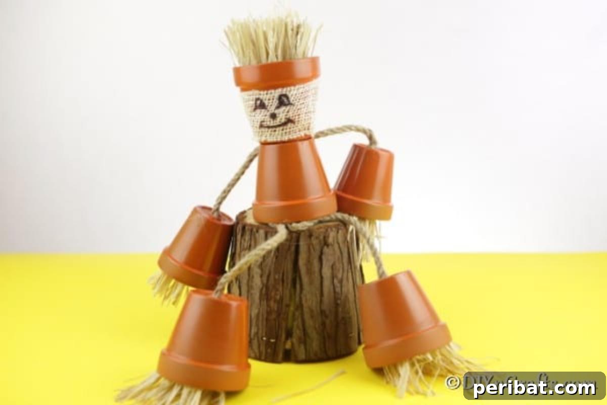 A scarecrow flower pot person sitting on a wooden stump on a yellow surface with white background