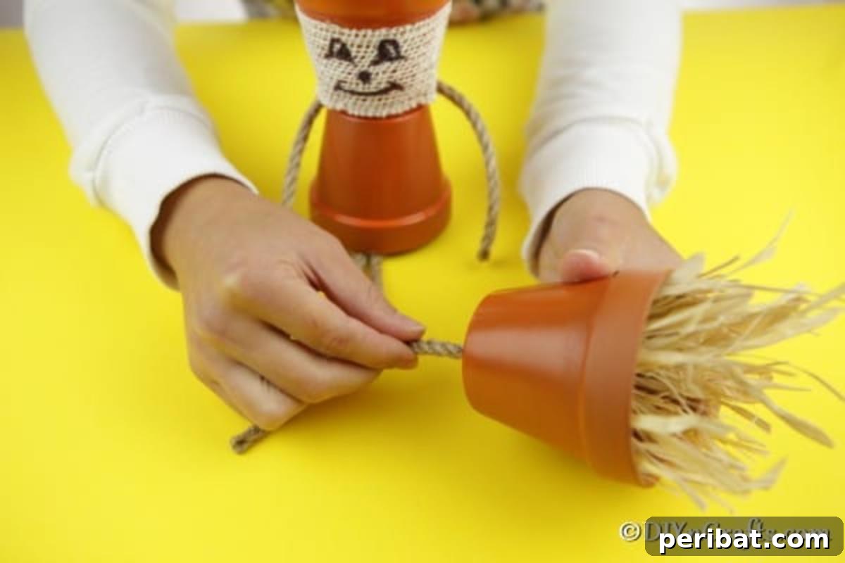Connecting the flower pot person body with rope and glue