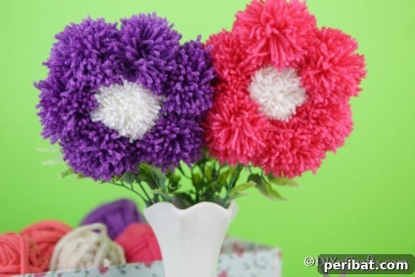 Yarn Pom-Pom Floral Displays 12 Up close picture of pink and purple pom pom flowers, highlighting the intricate yarn texture and vibrant colors.