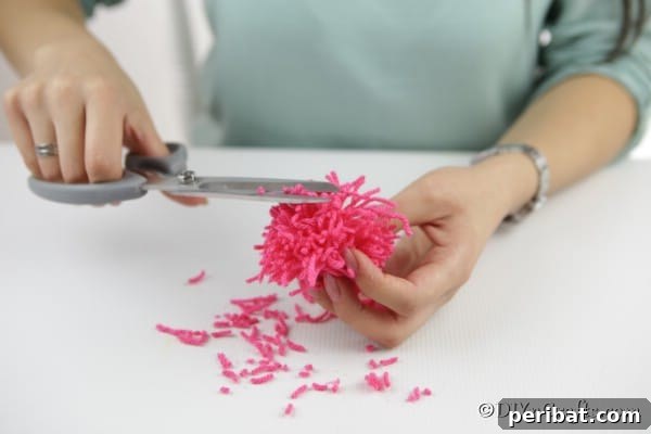 Yarn Pom-Pom Floral Displays 17 Trimming excess yarn from the outside of the flower pom pom