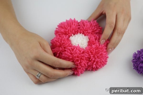 Yarn Pom-Pom Floral Displays 19 Securing yarn pom poms to cardboard to create a flower petal