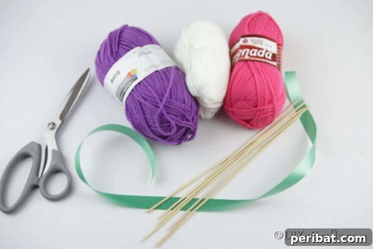 Yarn Pom-Pom Floral Displays 6 A curated collection of essential supplies laid out for crafting yarn pom pom flowers, including colorful yarns, scissors, and a hot glue gun.