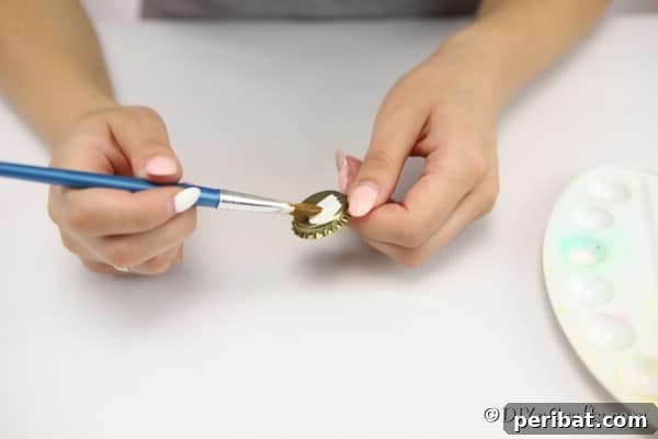 Painting bottle caps to create magnets