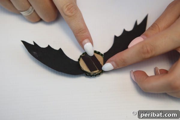 Adding a magnet to the back of the bottle cap bat
