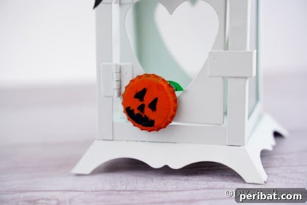 Close up picture of a pumpkin magnet on a white lantern