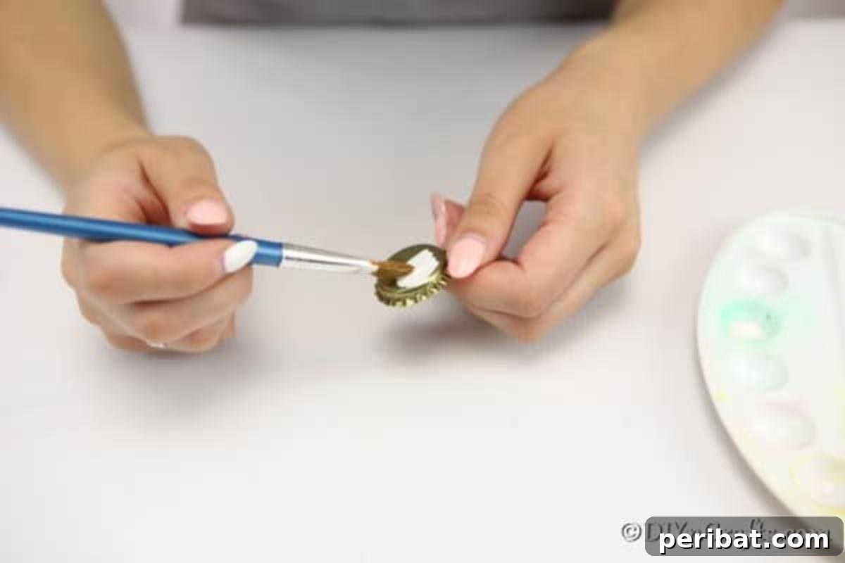 Painting bottle caps to create magnets