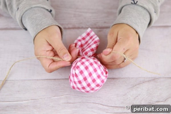 Cozy Plaid Tree Adornments 10 Wrapping the styrofoam ball in fabric for a christmas tree ornament