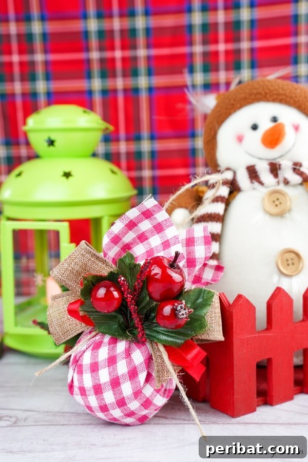 Cozy Plaid Tree Adornments 17 A checkered fabric ornament sitting on a counter next to other holiday decorations