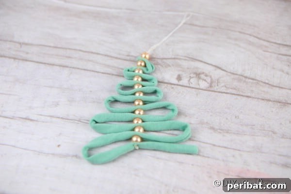 Ribbon and pearl Handmade Christmas Ornaments on a wooden surface