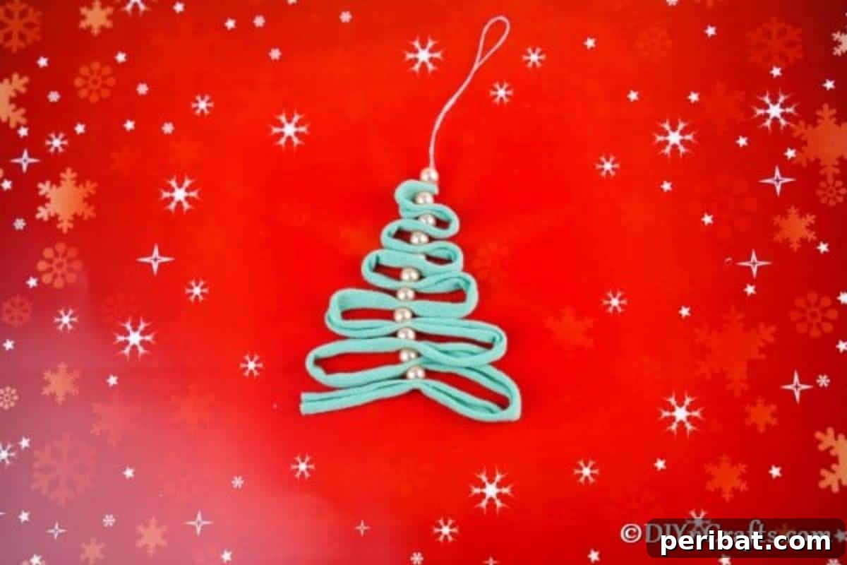 Pearl and ribbon handmade Christmas ornaments on a red holiday background