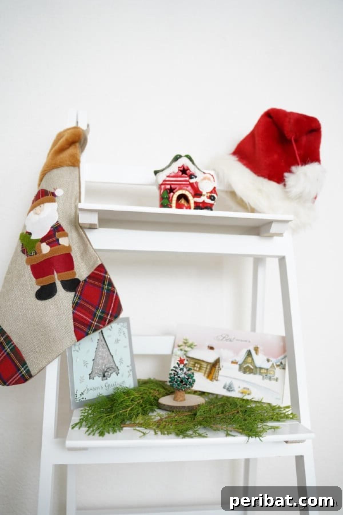 Tiny Pinecone Christmas Ornament 12 A beautifully decorated miniature pine cone ornament displayed on a pristine white shelf