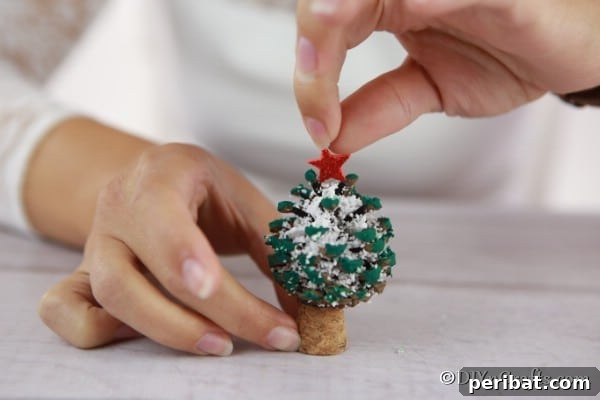 Tiny Pinecone Christmas Ornament 19 Adding the star to the top of a pine cone Christmas tree decoration