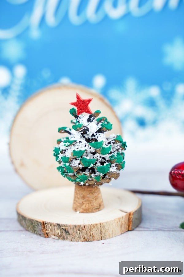 Tiny Pinecone Christmas Ornament 20 A charming pine cone ornament on a small slice of wood with a blue background, ready for display