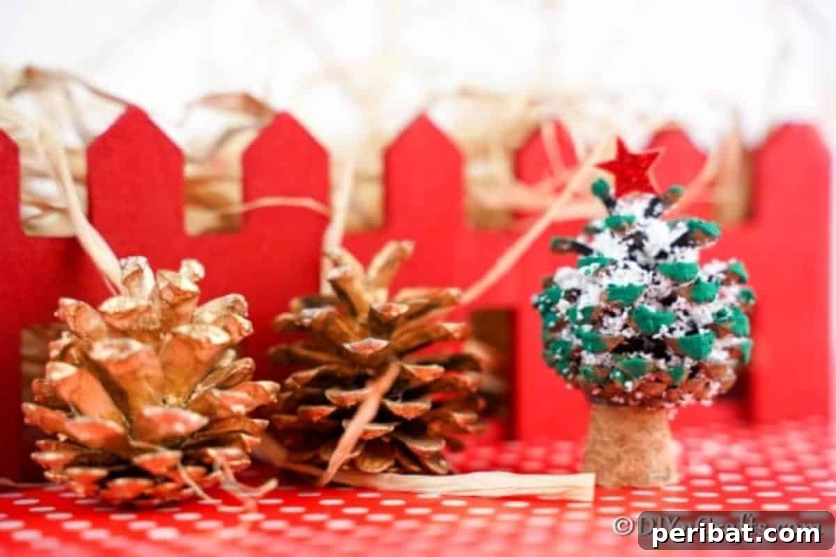 Tiny Pinecone Christmas Ornament 5 A mini pine cone Christmas tree ornament sitting on a festive red surface with a red fence in the background