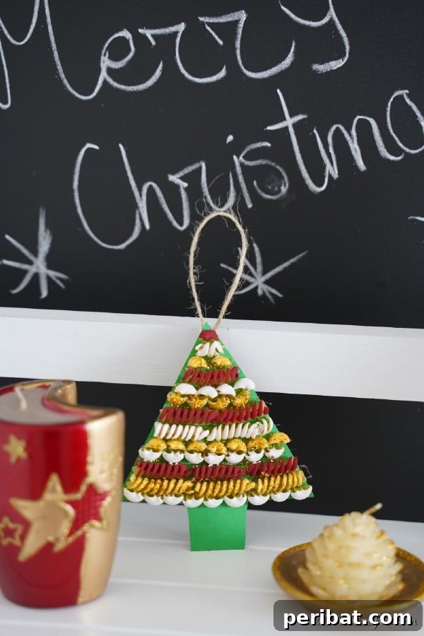 Whimsical Pasta Christmas Tree Decor 15 A pasta Christmas tree decoration leaned against a chalkboard with other holiday decor, showing a festive arrangement