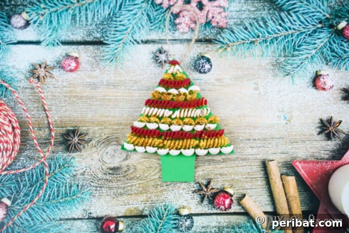 Whimsical Pasta Christmas Tree Decor 3 A completed pasta tree christmas decoration on a wooden table surrounded by blue garland and other festive elements