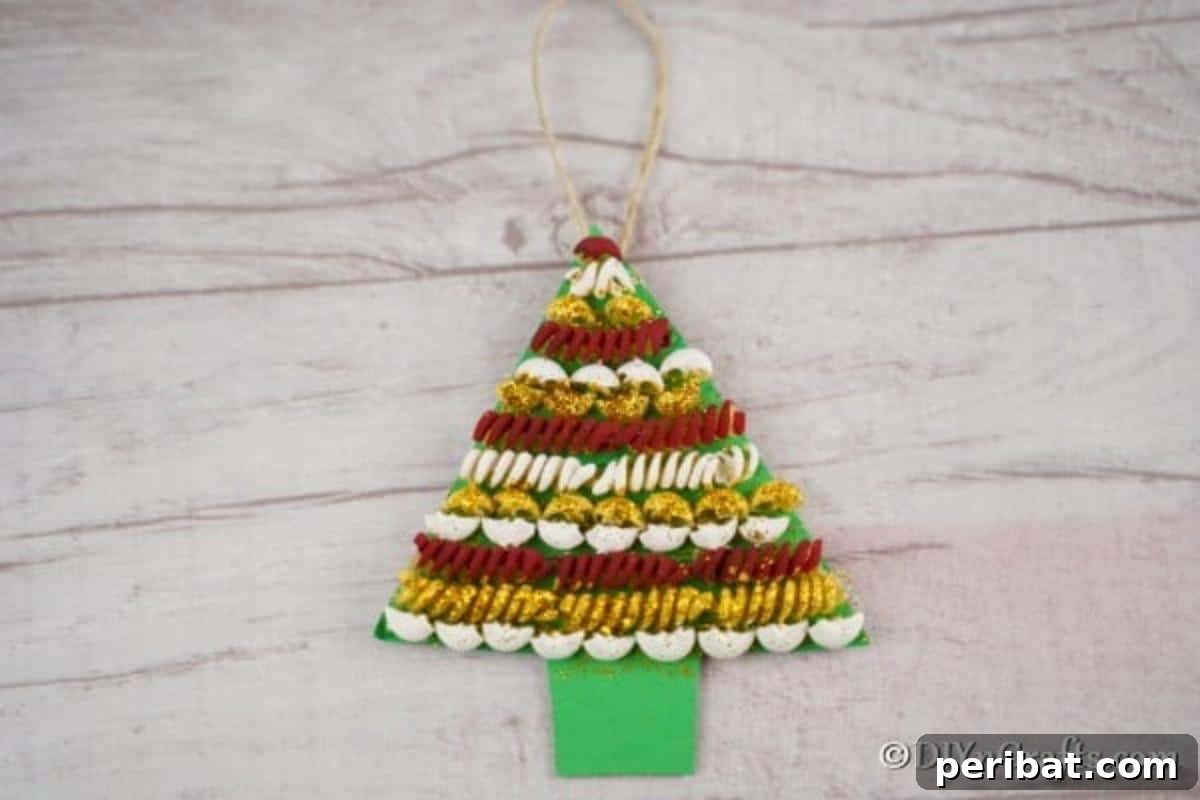 Whimsical Pasta Christmas Tree Decor 5 A simple pasta christmas tree laying on a wooden table, showcasing the craft's humble beginning