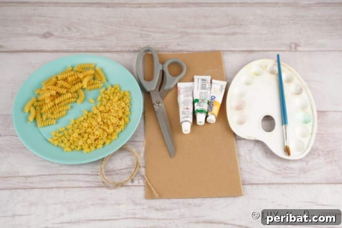 Whimsical Pasta Christmas Tree Decor 6 A flat lay of supplies for making pasta christmas decorations including pasta, cardboard, paints, and glitter
