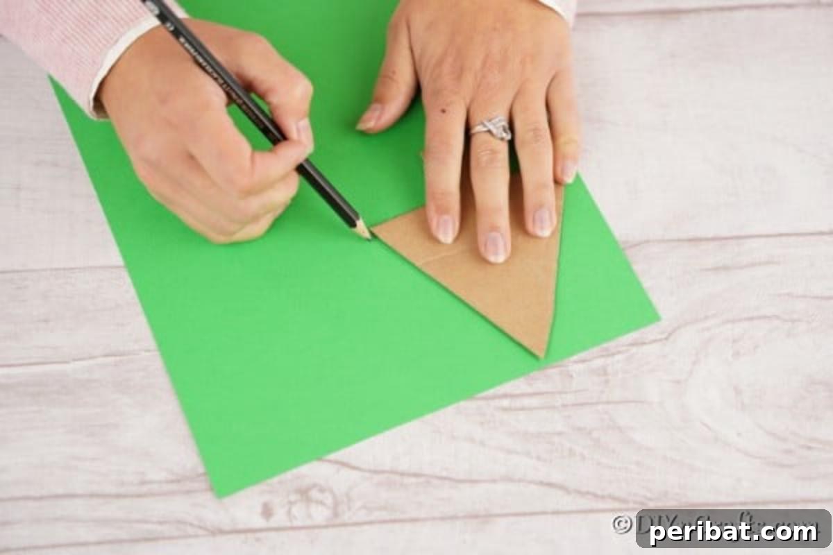 Whimsical Pasta Christmas Tree Decor 8 Cutting out a cardboard tree for the christmas tree craft