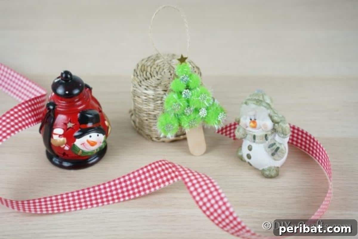 Whimsical Pom Pom Christmas Tree Decoration 5 A charming pom pom tree Christmas ornament arranged on a table with other festive Christmas figurines