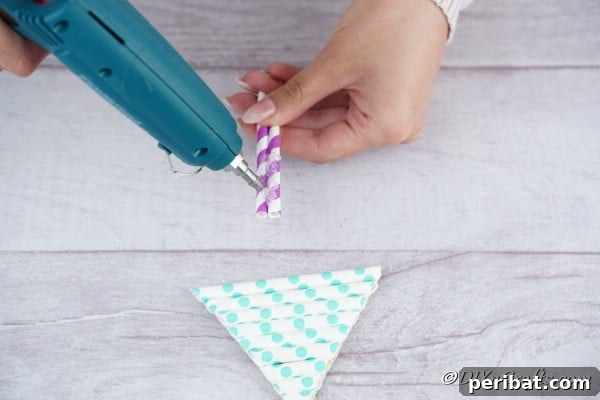 Gluing trunks to the bottom of a paper straw Christmas tree