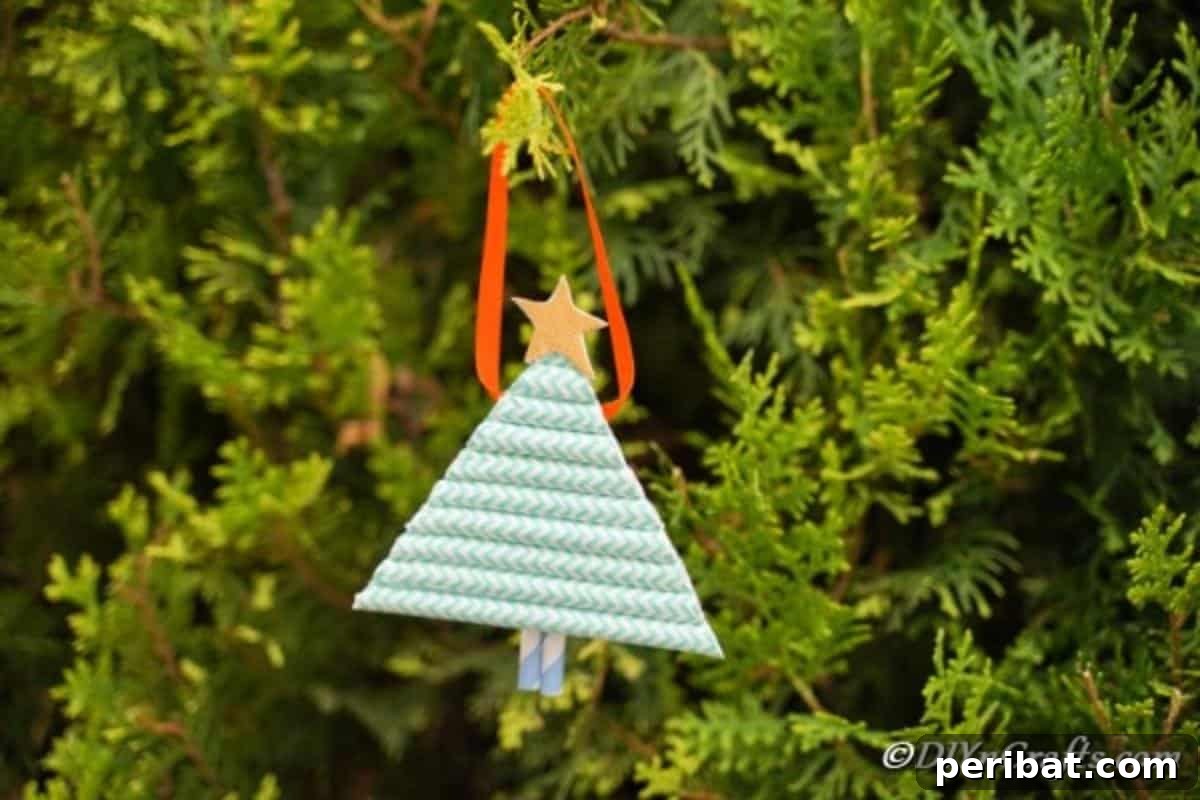 A paper Christmas tree hanging in a cedar tree