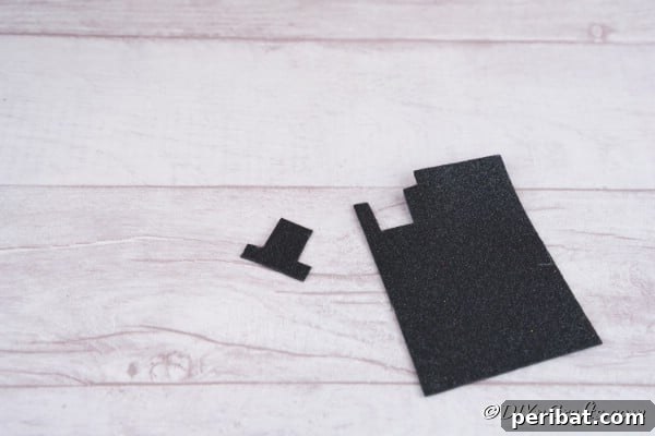 Cutting a black hat out of foam board to glue onto the Christmas candles