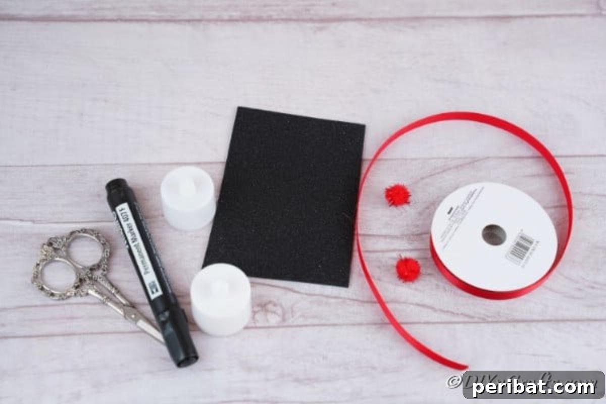 A selection of supplies laid out, including battery-operated tealight candles, foam board, pom poms, and ribbons, ready for crafting Santa and Snowman Christmas candles
