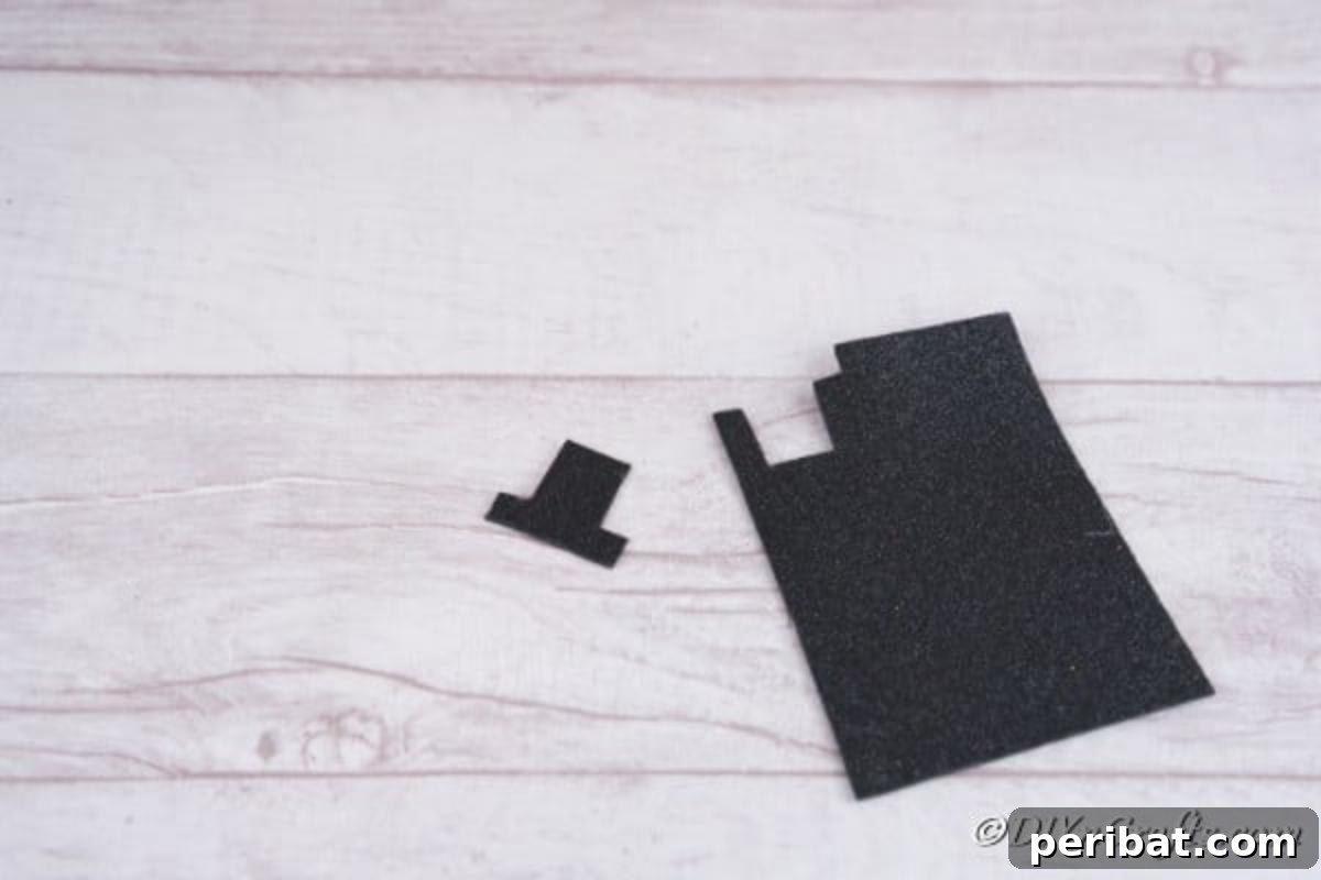 Carefully cutting a black top hat shape out of foam board, destined for the snowman Christmas candle