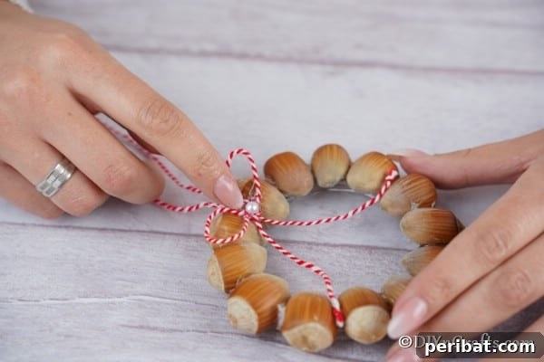 Handmade Rustic Hazelnut Christmas Ornaments 16 Adding a small bow to center of wreath with pearl