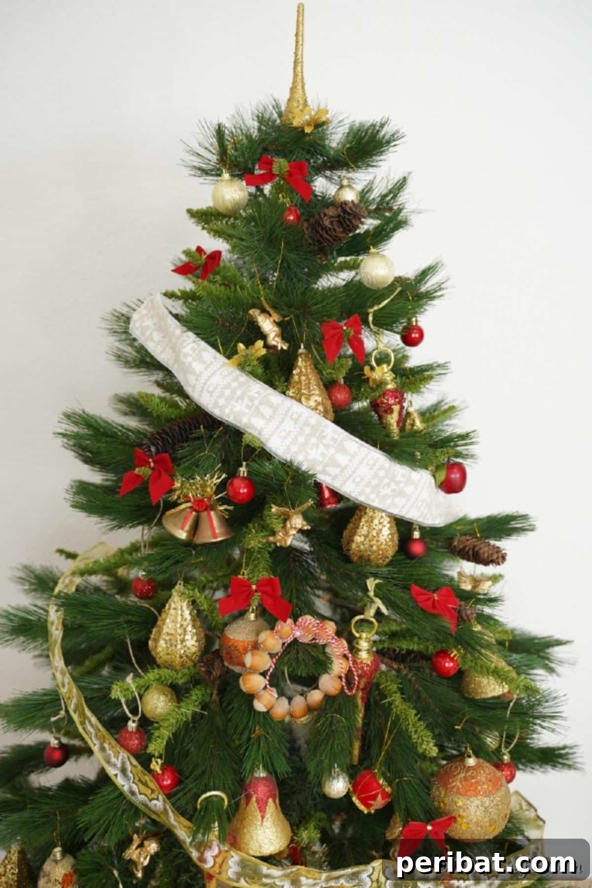 Handmade Rustic Hazelnut Christmas Ornaments 4 A beautifully decorated Christmas tree, featuring a rustic hazelnut Christmas decoration prominently displayed among other ornaments.