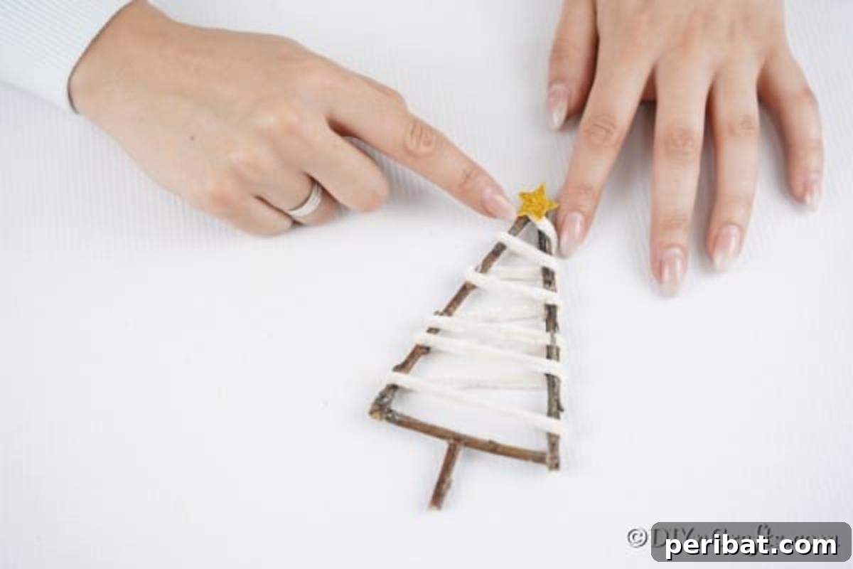 Gluing a star to the top of a twig rustic ornament 
