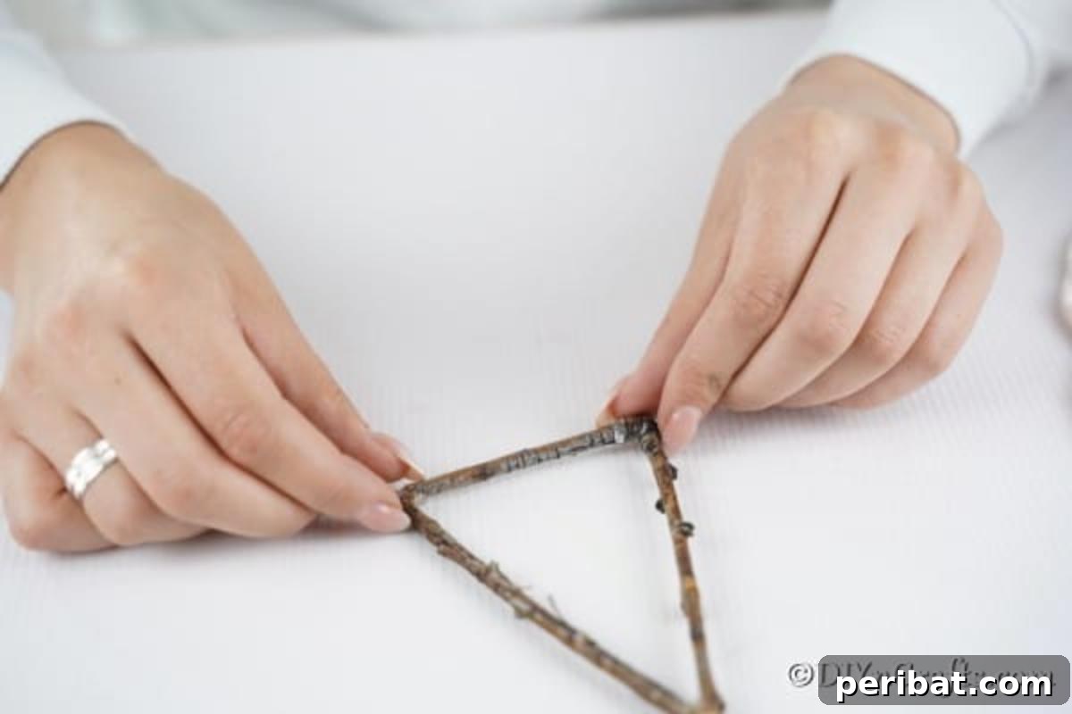 Gluing twigs together to form Christmas tree ornament