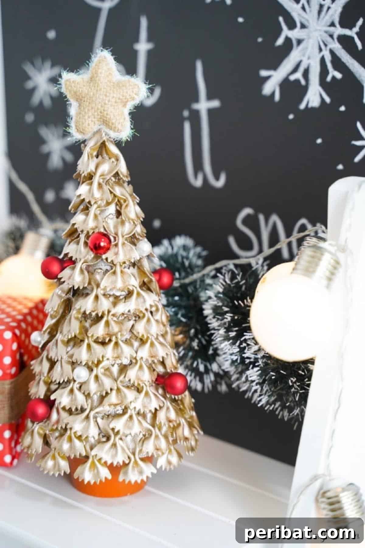 Creative Pasta Christmas Ornaments 6 A completed pasta Christmas tree showcased on a pristine white counter, with a festive Christmas chalkboard adding to the cheerful background ambiance.