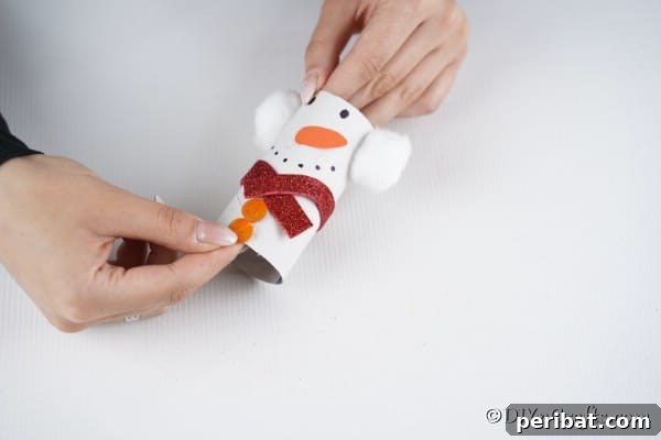 Upcycled Toilet Roll Santa Snowman and Elf for Kids 30 Gluing on a strip of red foam board to create a scarf on the snowman