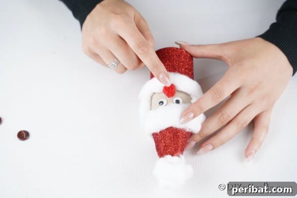 Upcycled Toilet Roll Santa Snowman and Elf for Kids 33 Adding the face to Santa toiler paper roll craft