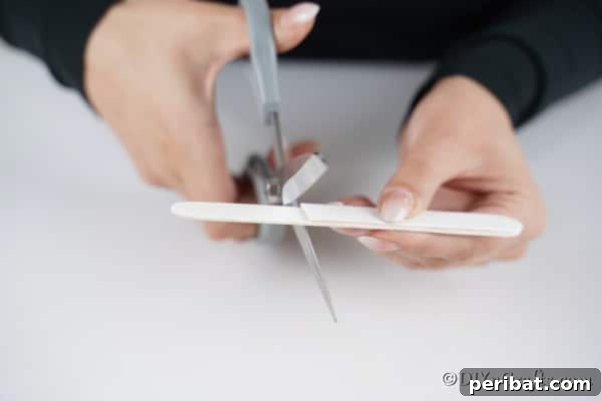 Cutting the craft sticks for the snowman craft stick ornament