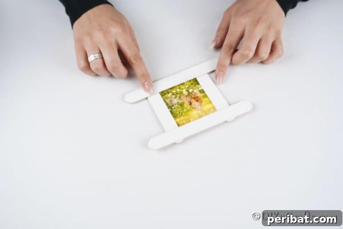 Gluing together the snowman picture frame