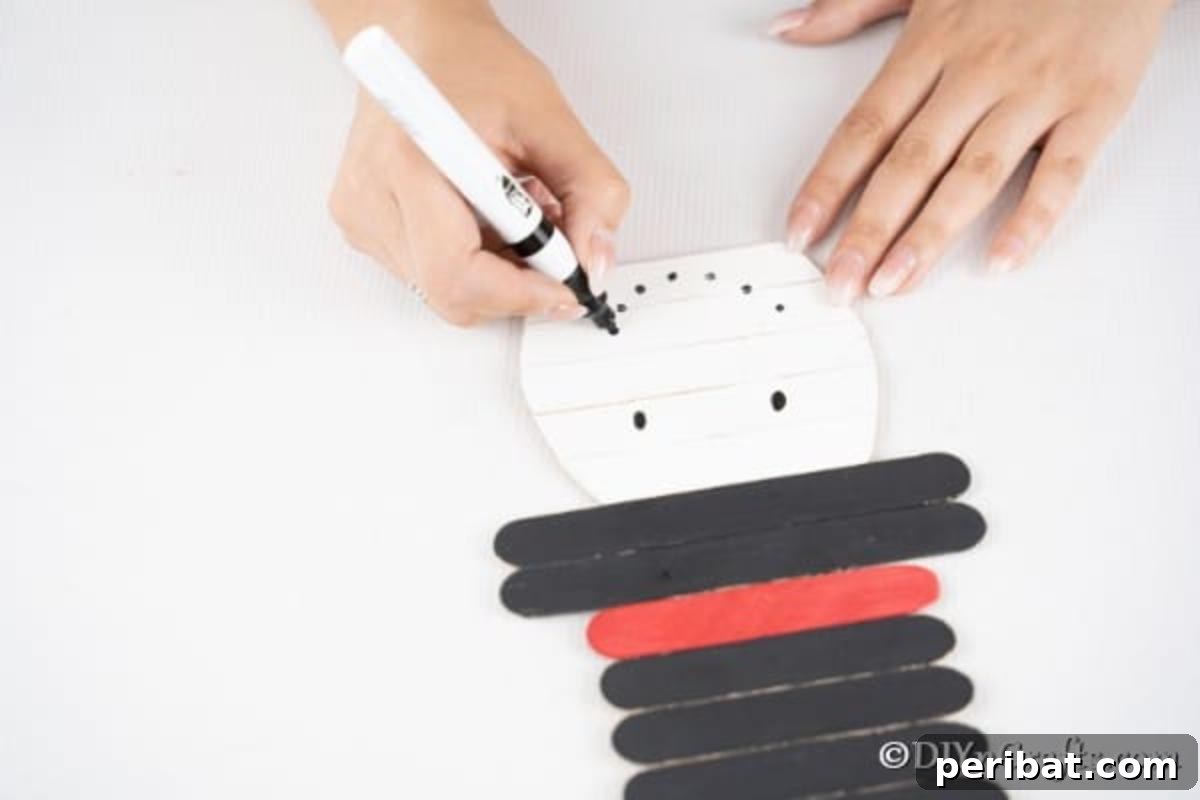 Adding a face to the craft stick snowman