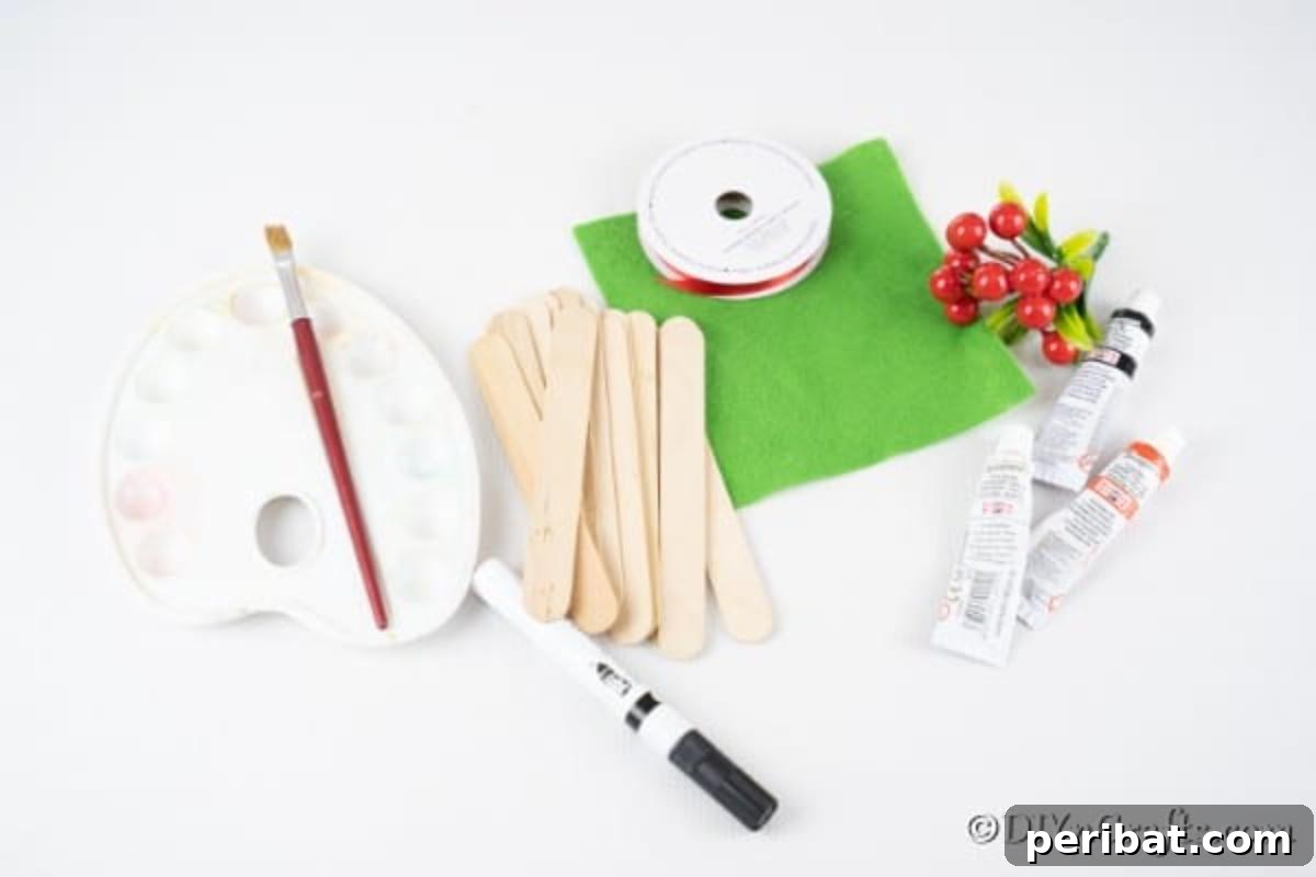 Supplies for making popsicle stick snowman laying on a table