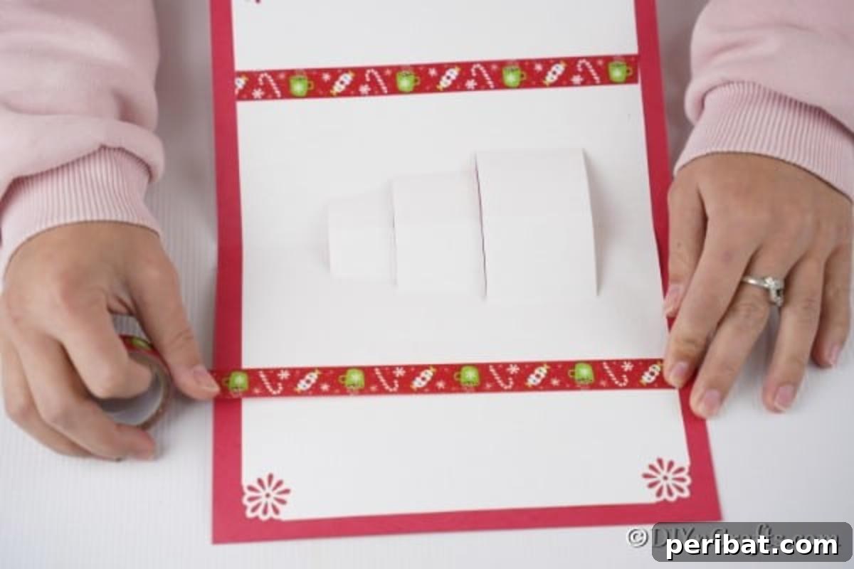 Attaching the card to the red cardstock with glue