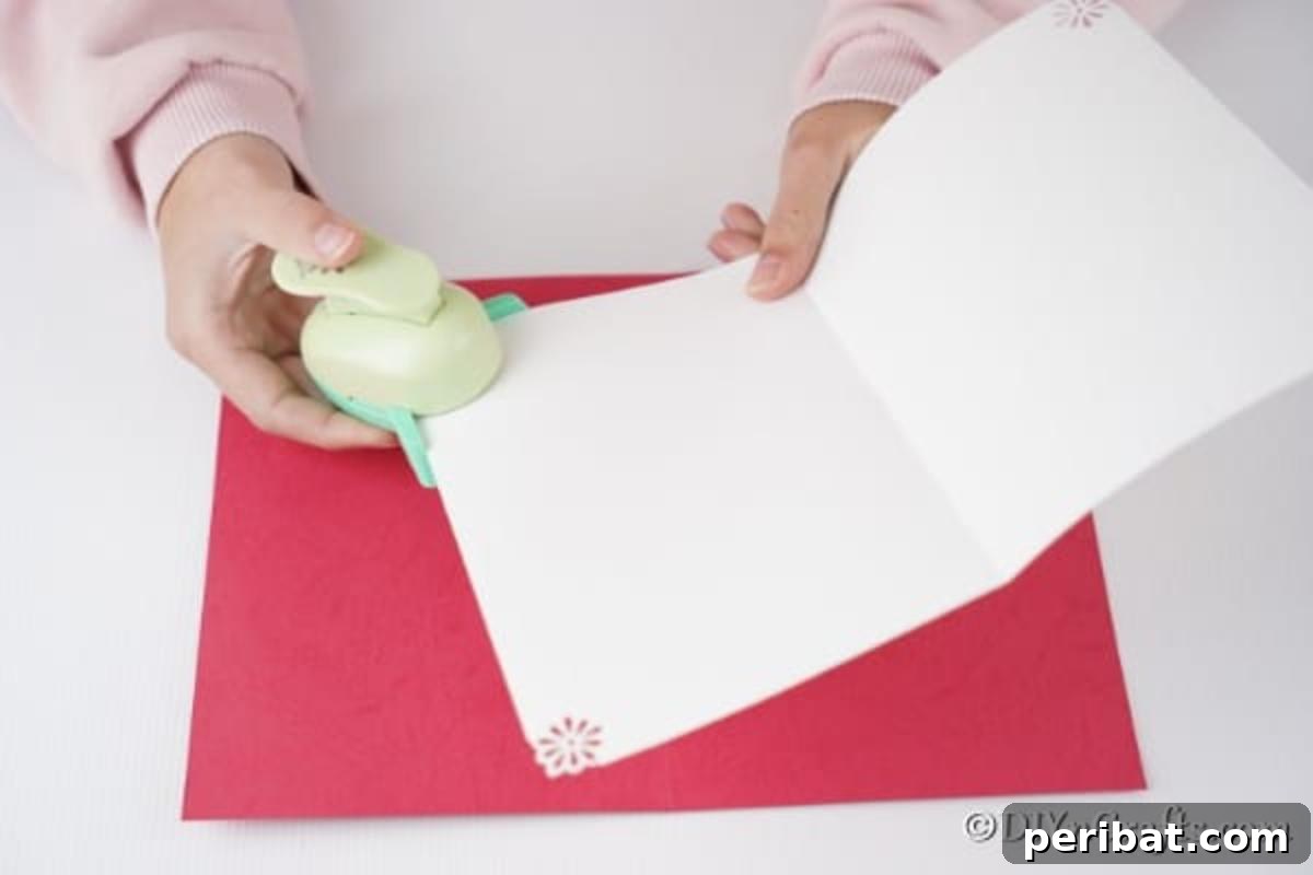 Folding and adding punches to the white card