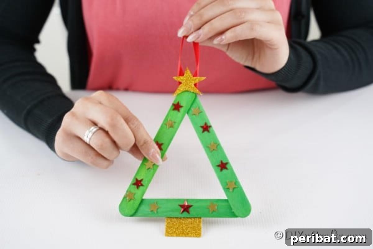 A completed christmas tree craft stick ornament