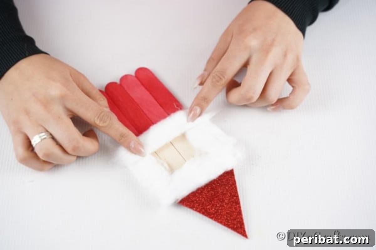 Adding cotton to create a face on your Santa ornament