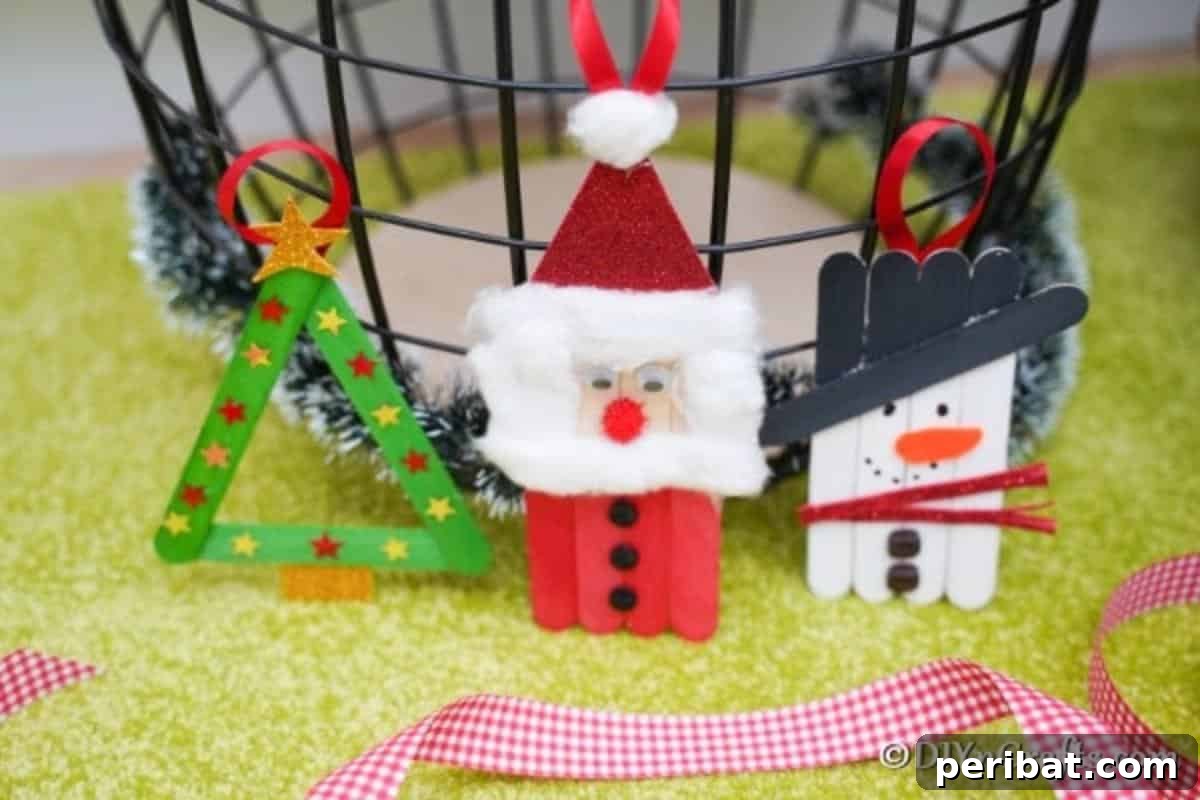 Three craft stick ornaments displayed on a green surface