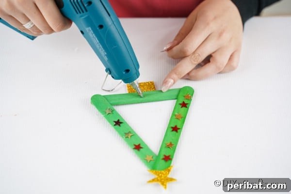 Decorating the popsicle stick Christmas tree