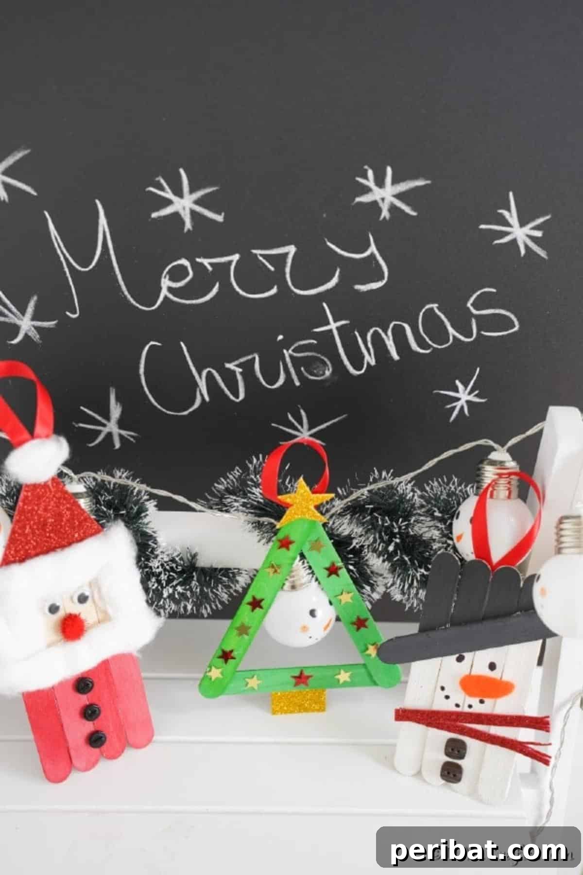 Santa snowman and tree craft stick ornaments on display in front of a holiday sign